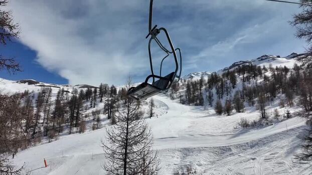 View of Sestriere ski slopes and trees under blue sky Italy. View of Sestriere ski slopes and trees under blue sky Italy.