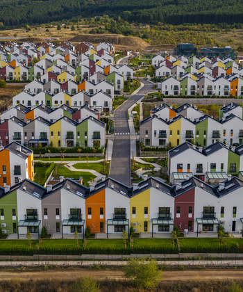 Aerial view of Residential Park Lozen with modern colorful townhouses manicured green lawns and paved roads in a suburban setting in Sofia Sofia City Province Bulgaria. Aerial view of Residential Park Lozen with modern colorful townhouses manicured green lawns and paved roads in a suburban setting in Sofia Sofia City Province Bulgaria.