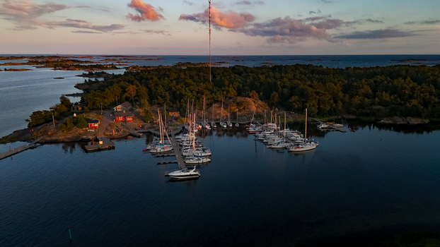 Aerial view of Oro Fortress Island marina with sailboats and motorboats moored at docks surrounded by forest and the calm waters of the Baltic Sea in Oro Varsinais Suomi Finland. Aerial view of Oro Fortress Island marina with sailboats and motorboats moored at docks surrounded by forest and the calm waters of the Baltic Sea in Oro Varsinais Suomi Finland.