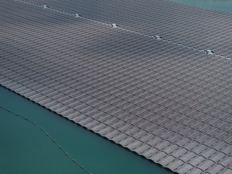 Aerial view of a large floating solar farm with rows of photovoltaic panels installed on the water surface in the Netherlands. Aerial view of a large floating solar farm with rows of photovoltaic panels installed on the water surface in the Netherlands.