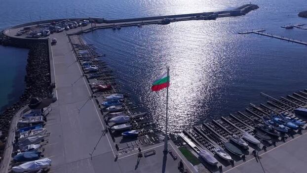 Aerial view of Varna marina with boats and Bulgarian flag Bulgaria.