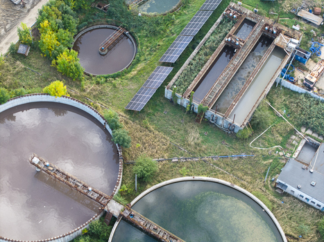 Aerial view of a wastewater treatment plant featuring circular sedimentation tanks rectangular aeration basins and solar panel arrays in Krakow Lesser Poland Voivode Poland.