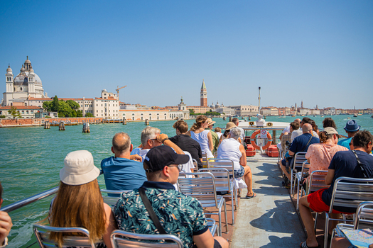 Venice Italy 29 March 2026 View of the Grand Canal shimmering under the sun with the Basilica di Santa Maria della Salute standing majestically against the azure sky. Venice Italy 29 March 2026 View of the Grand Canal shimmering under the sun with the Basilica di Santa Maria della Salute standing majestically against the azure sky.