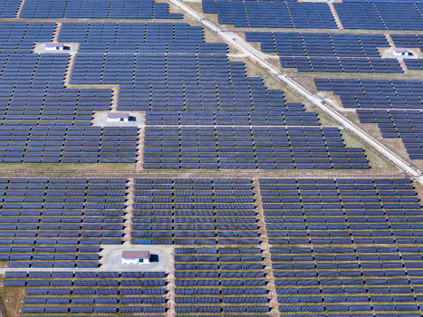 Aerial view of a large solar farm with rows of photovoltaic panels and maintenance buildings Torrazza Piemonte Piemonte Italy. Aerial view of a large solar farm with rows of photovoltaic panels and maintenance buildings Torrazza Piemonte Piemonte Italy.