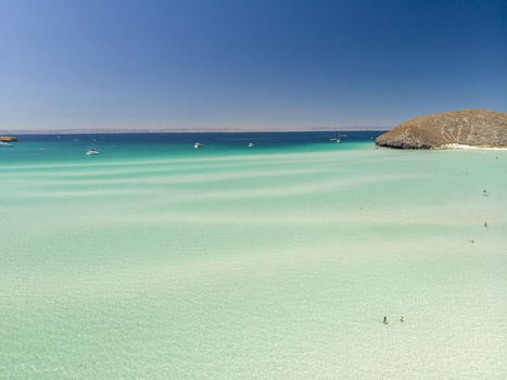 Aerial view of Balandra beach featuring turquoise shallow waters white sand ripples and a rocky headland in La Paz Baja California Sur Mexico. Aerial view of Balandra beach featuring turquoise shallow waters white sand ripples and a rocky headland in La Paz Baja California Sur Mexico.