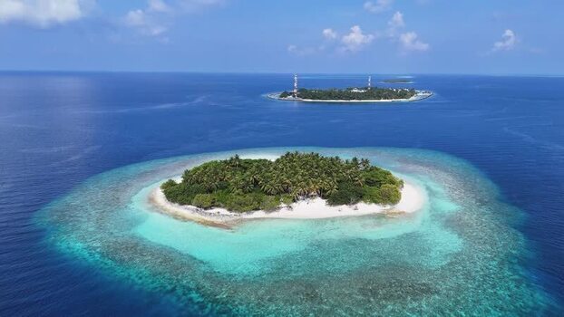 Aerial view of a tropical island with palm trees and coral reefs Maldives. Aerial view of a tropical island with palm trees and coral reefs Maldives.