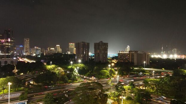 Aerial view of the Semanggi interchange with illuminated skyscrapers and heavy traffic at night in Kecamatan Setiabudi Daerah Khusus Ibukota Indonesia. Aerial view of the Semanggi interchange with illuminated skyscrapers and heavy traffic at night in Kecamatan Setiabudi Daerah Khusus Ibukota Indonesia.