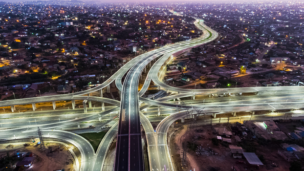 Aerial view of the illuminated Pokuase Interchange at night with multi level flyovers and surrounding urban sprawl in Ga North Municipal Greater Accra Region Ghana. Aerial view of the illuminated Pokuase Interchange at night with multi level flyovers and surrounding urban sprawl in Ga North Municipal Greater Accra Region Ghana.