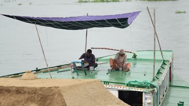 View of men on a boat at Aminbazar Bangladesh. View of men on a boat at Aminbazar Bangladesh.