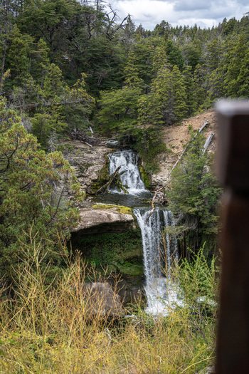 View of Cascada Nant y Fall a multi tiered waterfall surrounded by lush green forest and rocky terrain in Trevelin Chubut Argentina. View of Cascada Nant y Fall a multi tiered waterfall surrounded by lush green forest and rocky terrain in Trevelin Chubut Argentina.