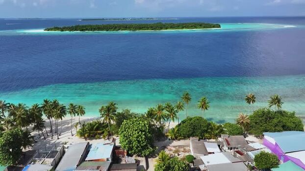 Aerial view of a tropical island with palm trees and turquoise water Maldives. Aerial view of a tropical island with palm trees and turquoise water Maldives.