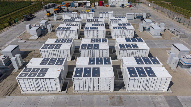 Aerial view of the Battery Energy Storage System at Wind Park with rows of white storage containers on a concrete site in Dronten Flevoland Netherlands. Aerial view of the Battery Energy Storage System at Wind Park with rows of white storage containers on a concrete site in Dronten Flevoland Netherlands.
