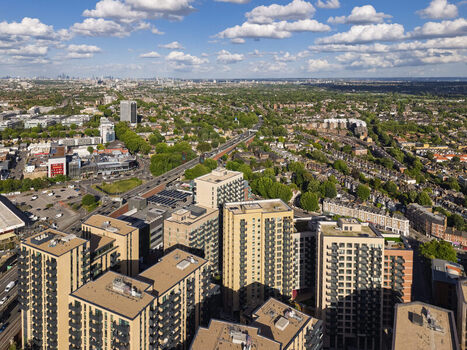 Aerial view of modern apartment buildings and residential areas with green trees and roads in Brentford England United Kingdom. Aerial view of modern apartment buildings and residential areas with green trees and roads in Brentford England United Kingdom.