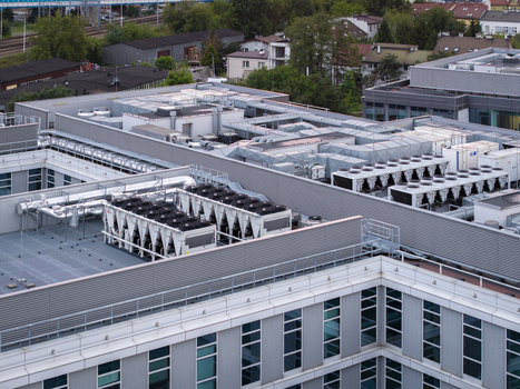 Aerial view of industrial HVAC cooling systems and data center infrastructure on a modern building rooftop in Krakow Lesser Poland Voivode Poland.