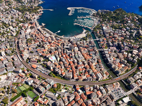 Aerial view of the coastal town with its harbor dense urban architecture and railway line under a clear blue sky Rapallo Liguria Italy. Aerial view of the coastal town with its harbor dense urban architecture and railway line under a clear blue sky Rapallo Liguria Italy.