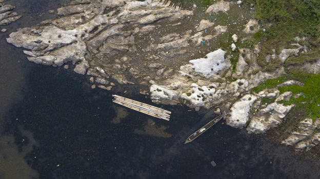 Danau Kerinci Jambi Indonesia 25 September 2026 Aerial view of Danau Kerinci showing a rocky shoreline dark water a bamboo raft and a small wooden boat. Danau Kerinci Jambi Indonesia 25 September 2026 Aerial view of Danau Kerinci showing a rocky shoreline dark water a bamboo raft and a small wooden boat.