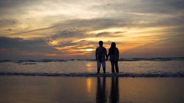 View of a couple holding hands on the beach at sunset Bangladesh. View of a couple holding hands on the beach at sunset Bangladesh.