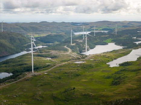 Aerial view of Makaknuten Vindkraftverk wind farm with large turbines situated on a rugged green landscape with lakes and winding roads in Bjerkreim Municipality Rogaland Norway. Aerial view of Makaknuten Vindkraftverk wind farm with large turbines situated on a rugged green landscape with lakes and winding roads in Bjerkreim Municipality Rogaland Norway.