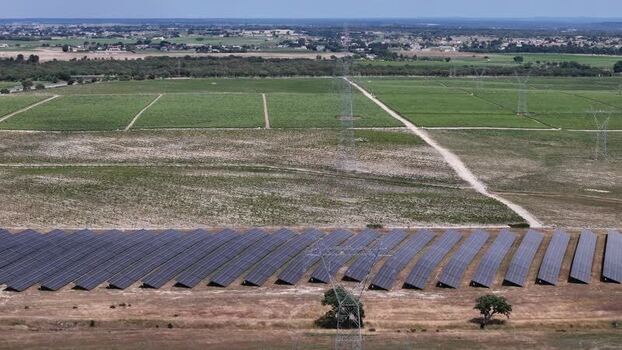 Aerial view of a solar farm and power lines in the countryside Portugal.