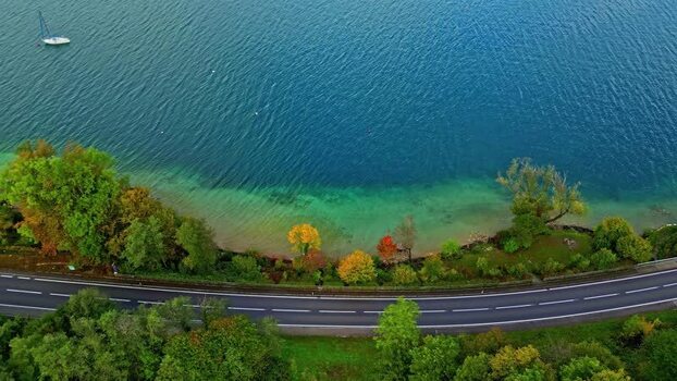 Aerial view of Attersee lake and coastal road Austria.