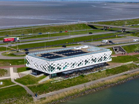Kornwerderzand Netherlands 14 May 2026 Aerial view of Afsluitdijk Wadden Center featuring its hexagonal honeycomb facade and solar panels on the roof near the highway. Kornwerderzand Netherlands 14 May 2026 Aerial view of Afsluitdijk Wadden Center featuring its hexagonal honeycomb facade and solar panels on the roof near the highway.