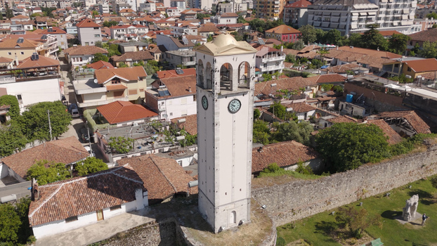 Aerial view of the Clock Tower of Elbasan surrounded by historic rooftops stone walls and lush greenery in Elbasan Qarku i Elbasanit Albania.
