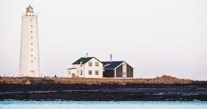 View of lighthouse and buildings Iceland.