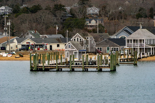 View of the historic harbor front and wooden pier with shingled buildings along the coastline of Martha s Vineyard in Edgartown Massachusetts United States.