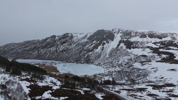 Aerial view of Lofoten mountains and frozen lake in Norway.