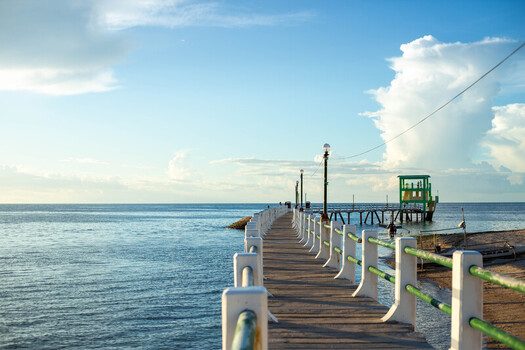 View of the pier leading to a small structure over the calm sea at Bantayan Island Cebu Central Visayas Philippines. View of the pier leading to a small structure over the calm sea at Bantayan Island Cebu Central Visayas Philippines.