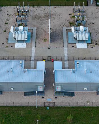 Aerial view of an advanced power substation featuring large electrical transformers metal utility buildings and gravel grounds in Warsaw Masovian Voivodeship Poland. Aerial view of an advanced power substation featuring large electrical transformers metal utility buildings and gravel grounds in Warsaw Masovian Voivodeship Poland.
