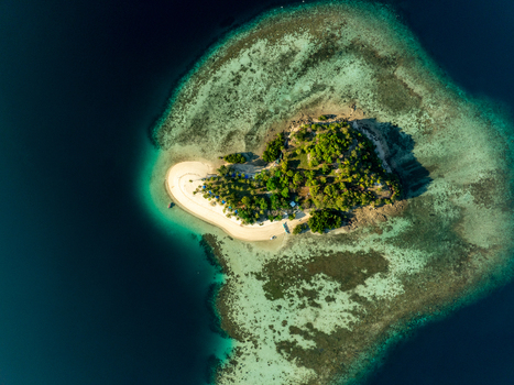 Aerial view of Pass Island surrounded by turquoise coral reefs and clear blue water in Coron Philippines. Aerial view of Pass Island surrounded by turquoise coral reefs and clear blue water in Coron Philippines.
