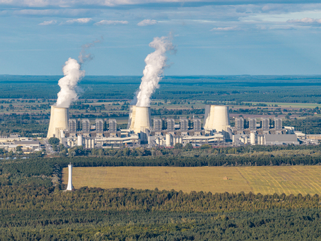 Aerial view of Janschwalde Power Station with cooling towers emitting steam plumes surrounded by vast forests and agricultural fields in Peitz Brandenburg Germany. Aerial view of Janschwalde Power Station with cooling towers emitting steam plumes surrounded by vast forests and agricultural fields in Peitz Brandenburg Germany.
