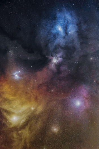 View of the colorful Rho Ophiuchi cloud complex featuring vibrant blue reflection nebulae dark cosmic dust lanes and glowing emission regions in the night sky of Poland. View of the colorful Rho Ophiuchi cloud complex featuring vibrant blue reflection nebulae dark cosmic dust lanes and glowing emission regions in the night sky of Poland.