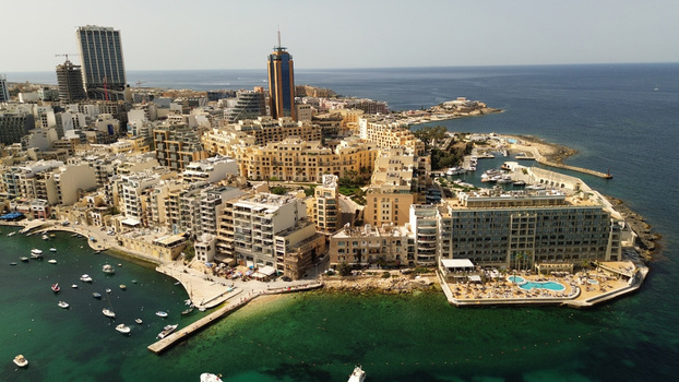 Aerial view of the Portomaso Marina with its modern high rise buildings luxury apartments and yachts docked in the harbor along the Mediterranean coastline of Malta. Aerial view of the Portomaso Marina with its modern high rise buildings luxury apartments and yachts docked in the harbor along the Mediterranean coastline of Malta.