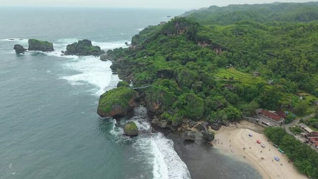 Aerial view of Siung Beach with rocky cliffs and hills Indonesia.