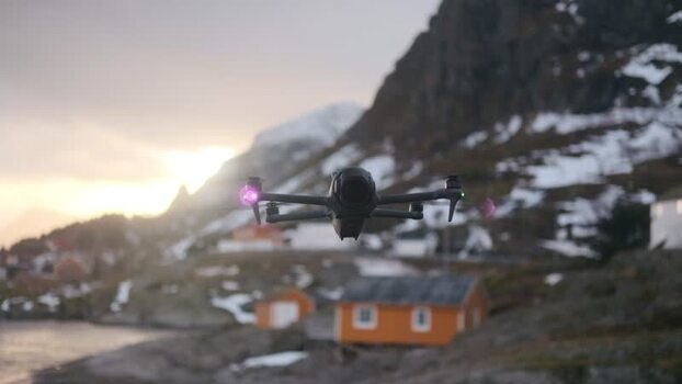 View of a drone flying over a snowy coastal village Norway.