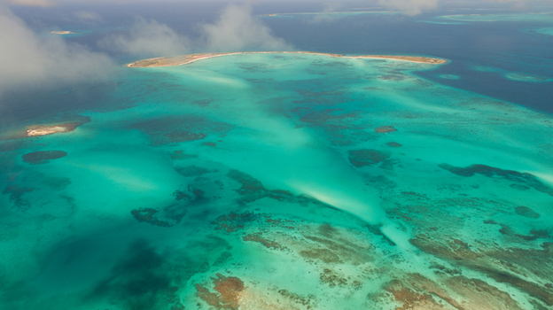 Aerial view of Los Roques archipelago with turquoise waters coral reefs and sandy islands under a clear sky in Los Roques Dependencias Federales Venezuela. Aerial view of Los Roques archipelago with turquoise waters coral reefs and sandy islands under a clear sky in Los Roques Dependencias Federales Venezuela.