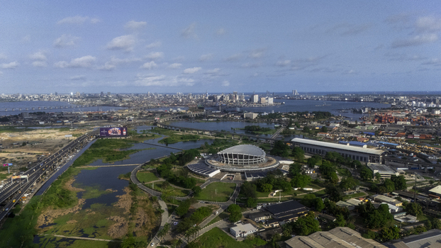 Aerial view of the Wole Soyinka Centre for Culture and Creative Arts National Theatre Nigeria surrounded by greenery and lagoons with the city skyline in Lagos Lagos Nigeria. Aerial view of the Wole Soyinka Centre for Culture and Creative Arts National Theatre Nigeria surrounded by greenery and lagoons with the city skyline in Lagos Lagos Nigeria.