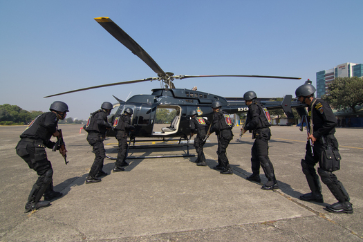 Dhaka Bangladesh 19 January 2017 View of RAB personnel in tactical gear approaching a black helicopter at the RAB Headquarters under a clear blue sky. Dhaka Bangladesh 19 January 2017 View of RAB personnel in tactical gear approaching a black helicopter at the RAB Headquarters under a clear blue sky.