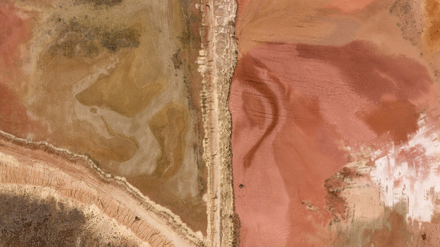 Aerial view of salt pans and industrial patterns showing brown and yellow sand deposits after a storm near Useless Loop in Kalbarri Western Australia Australia. Aerial view of salt pans and industrial patterns showing brown and yellow sand deposits after a storm near Useless Loop in Kalbarri Western Australia Australia.