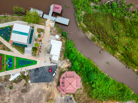 Aerial view of Urban Park featuring modern buildings a river green spaces and a parking area in Alalak South Kalimantan Indonesia.