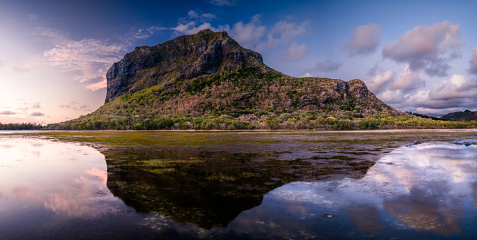 Aerial view of Le Morne Brabant mountain reflected in the calm lagoon waters during a colorful sunset in Moka District Mauritius. Aerial view of Le Morne Brabant mountain reflected in the calm lagoon waters during a colorful sunset in Moka District Mauritius.