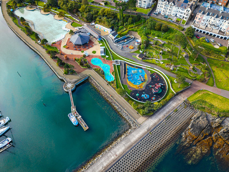Aerial view of Bangor Harbour and Town featuring a recreational park with swimming pools a playground and a marina with boats docked at the pier in Bangor Northern Ireland United Kingdom.