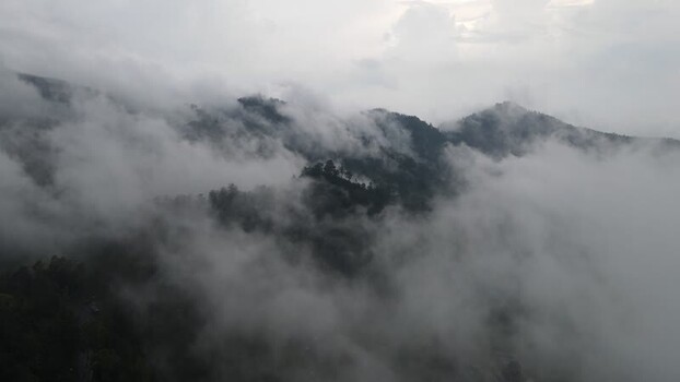 Aerial view of misty mountains and forests in Indonesia. Aerial view of misty mountains and forests in Indonesia.