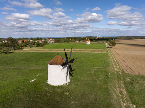 Aerial view of the historic Regi Szelmalom windmills set in green fields with a blue sky in Tes Hungary. Aerial view of the historic Regi Szelmalom windmills set in green fields with a blue sky in Tes Hungary.