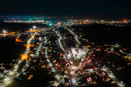 Aerial view of fireworks exploding over the illuminated residential rooftops and streets of Forchheim Bavaria Germany. Aerial view of fireworks exploding over the illuminated residential rooftops and streets of Forchheim Bavaria Germany.