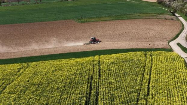Aerial view of tractor on farmland France.