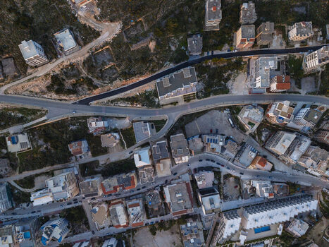 Aerial view of the coastal city of Sarande featuring dense urban development winding roads and modern apartment buildings in Saranda Vlore County Albania. Aerial view of the coastal city of Sarande featuring dense urban development winding roads and modern apartment buildings in Saranda Vlore County Albania.