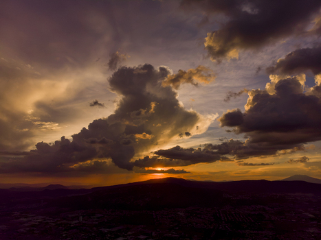 Aerial view of a dramatic sunset over the landscape and urban area of Tlaquepaque Jalisco Mexico. Aerial view of a dramatic sunset over the landscape and urban area of Tlaquepaque Jalisco Mexico.
